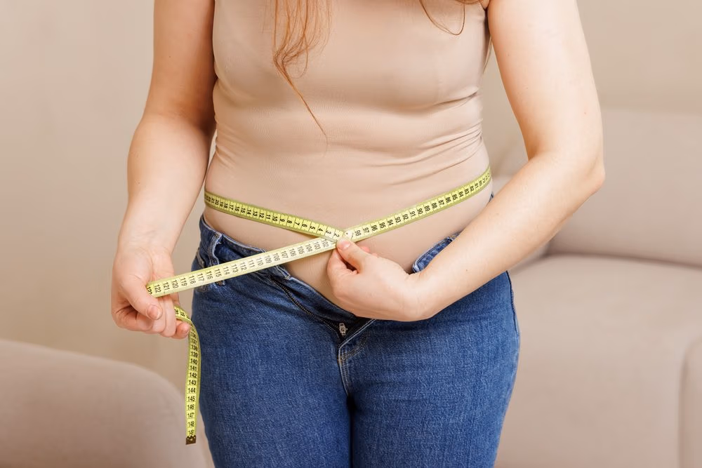 Close Up Of Woman Measuring Waist With Tape Close Up Of Woman Measuring Waist With Tape